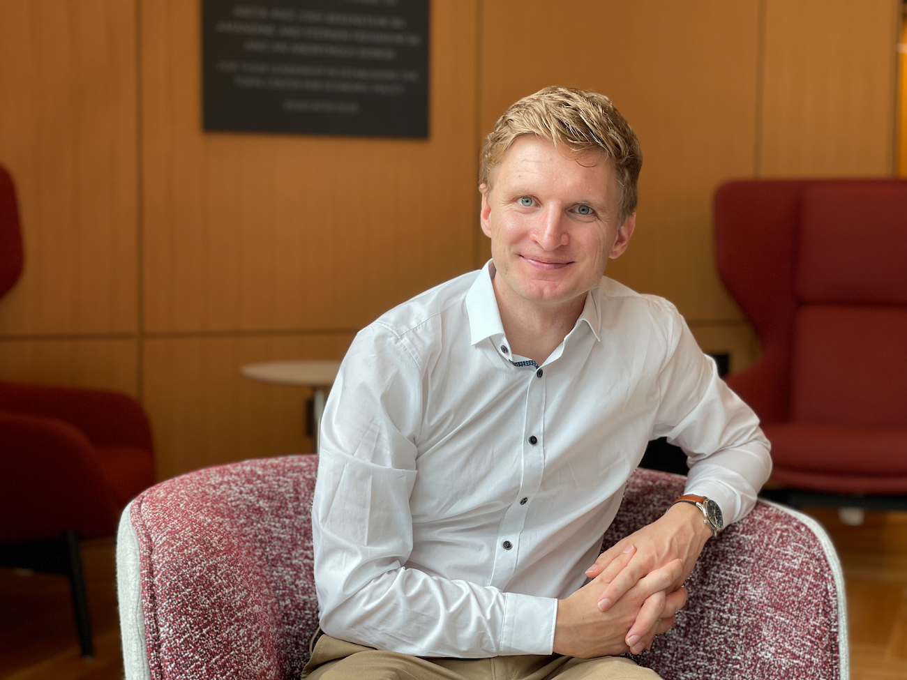 Photo of Patrick Agte sitting in the lounge at 87 Trumbull Street. 