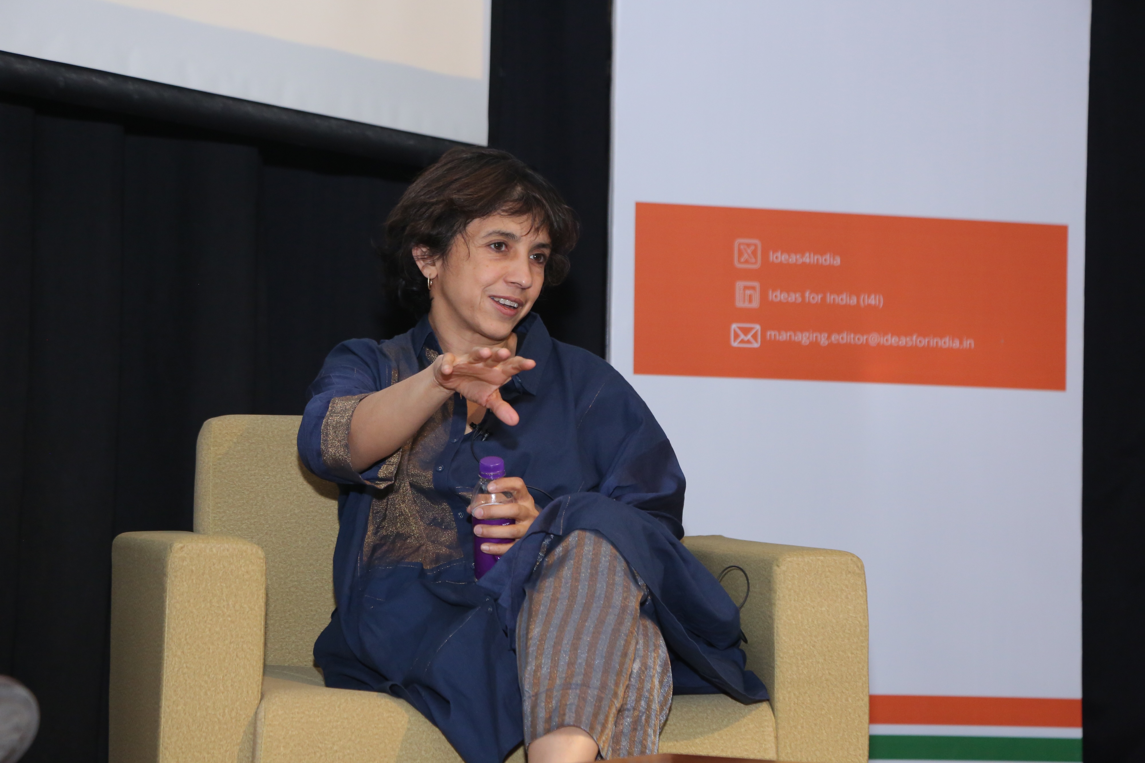 Rohini Pande speaking on stage