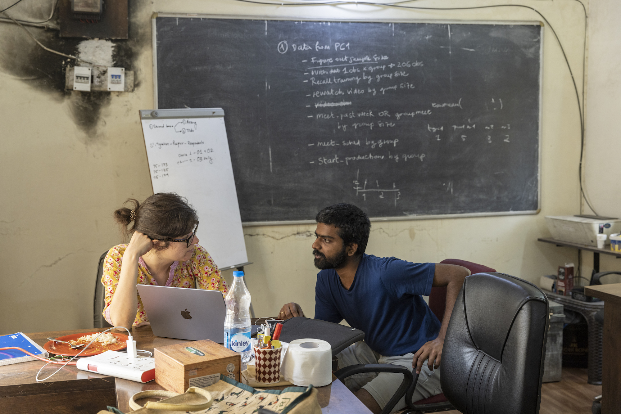 To researchers at a desk in an office in India