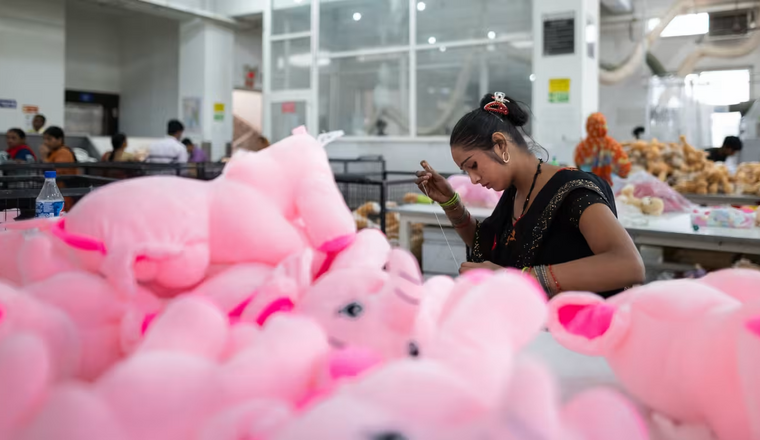 A woman operating sewing in a toy factory in India.