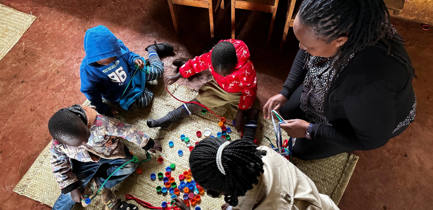 Teacher with children in a preschool in Kenya